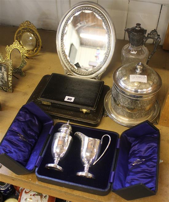 Cased silver jug and caster, cased knives, cased desert forks and knives, oval mirror, plated biscuit barrel and a claret jug